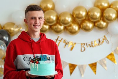 Boy with birthday cake and number 18