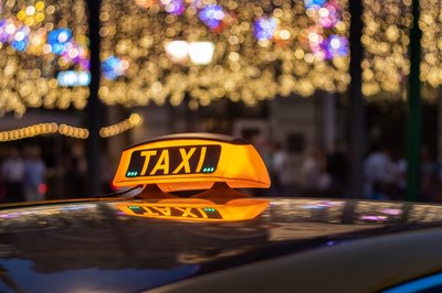 taxi light with Christmas lights in the background