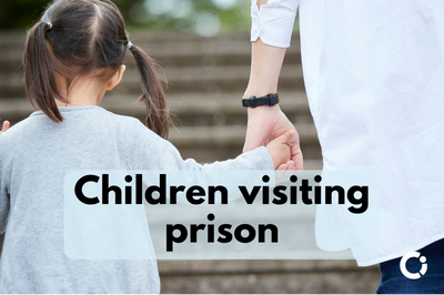 Adult holds child’s hand as they walk up steps. Text reads: "Children visiting prison"