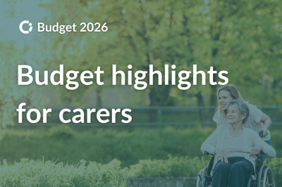 Carer pushing an older woman using a wheelchair as they enjoy the trees outdoors. Text reads “Budget highlights for carers”.