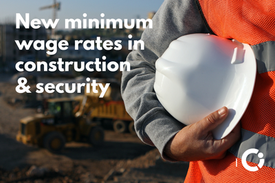 Construction worker in orange jacket holds a white safety helmet. Text reads: "New minimum wage rates in construction & security"