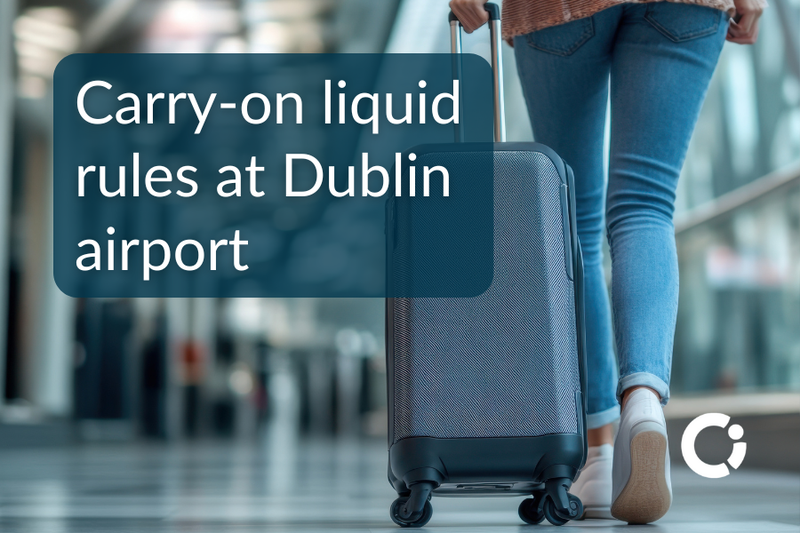 Woman pulls her carry-on luggage at airport. Text reads “Carry-on liquid rules at Dublin airport”