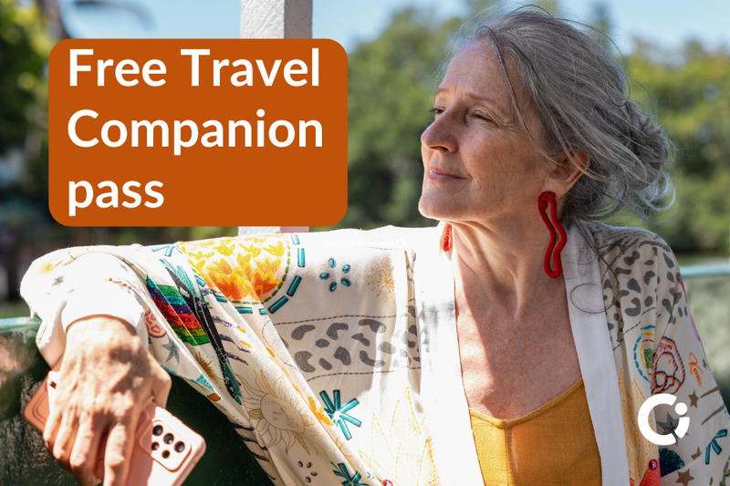 Older woman looks out at the countryside from a bus. Text reads: "Free Travel Companion pass"